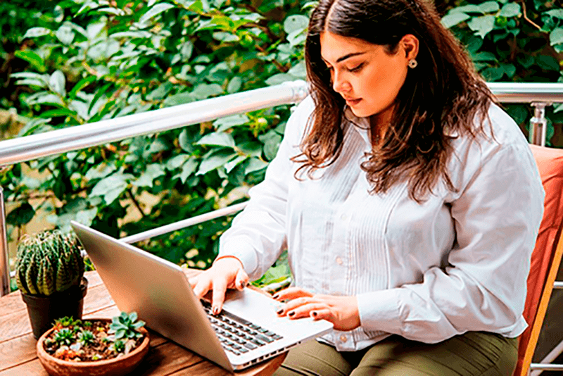 Woman outside on her laptop